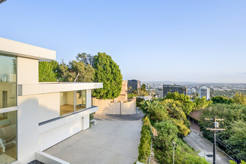 Spacious balcony with a wide window overlooking A cityscape