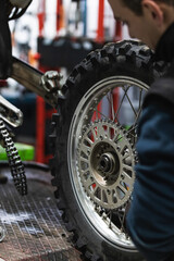 Fototapeta premium mechanic fixing motocycle wheel