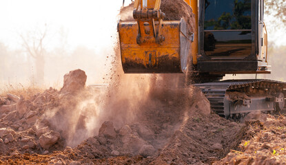 Close-up of excavator at construction site. Backhoe digging soil for earthwork and construction...