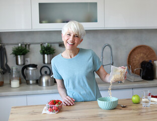 kitchen food woman healthy morning mature breakfast active fitness diet home healthy eating senior adult healthy lifestyle fruit sport fit health eating preparation nutrition female