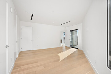 Obraz premium Empty room with white walls and a wooden floor. Home interior. California, USA