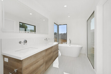 Fototapeta premium Bathroom featuring a bathtub, two sinks, and large windows. California, USA