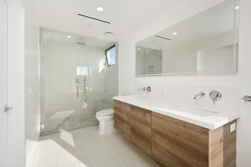 Modern and airy bathroom with illuminated light and a large mirror. California, USA