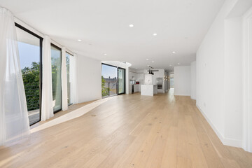 Spacious living room with wooden floors and big windows. California, USA
