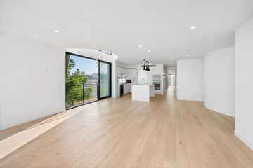 Spacious living room with hardwood floors and glass doors opening to the yard. California, USA