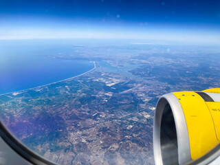 Airplane flight. Wing of an airplane flying above the clouds and sea in La Palma, Canary Islands....
