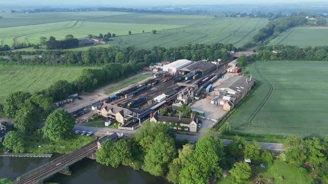 Drone view of Nene Valley Railway in Peterborough surrounded by green fields and the river Nene