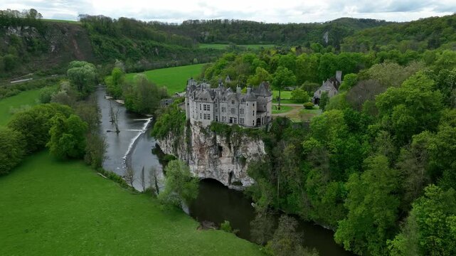 Aerial footage of Walzin Castle on a hill over the river Lesse in Dinant, Walloon Region, Belgium