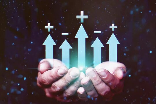 Video of hand holding chart with plus and minus symbol on chart. Concept of business income and expenses