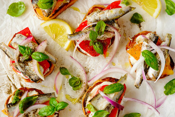 Crostini with sardines, tomatoes, mayonnaise and basi .top veiw