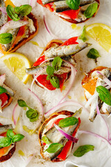 Crostini with sardines, tomatoes, mayonnaise and basi .top veiw