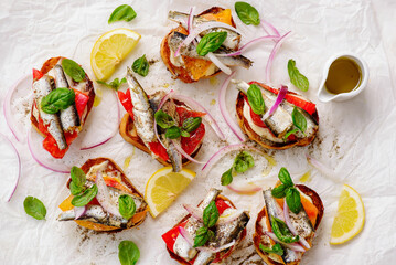Crostini with sardines, tomatoes, mayonnaise and basi .top veiw