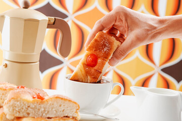 dipping catalan coca de sant joan in hot chocolate