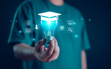 Male graduate diploma course holding a light bulb showing a graduation cap Study knowledge for...