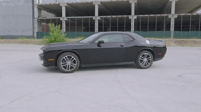 Iconic Black Dodge Challenger, embodying American muscle car prowess, in this thrilling video.