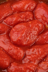 Whole peeled tomatoes, covered with tomato juice. Italian food ingredient