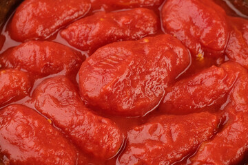 Whole peeled tomatoes, covered with tomato juice. Italian food ingredient