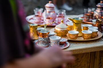 Traditional handmade souvenir from Bosnia and Herzegovina - turkish coffee pot with small copper cups. Bosnian coffee sets in the bazaar.