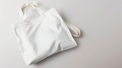 A white tote bag on a light grey background