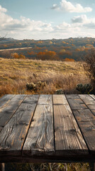 Obraz premium Majestic Outdoor Landscape with a Rustic Wooden Table Overlooking a Serene Countryside During Autumn with Rolling Hills and Vast Open Sky