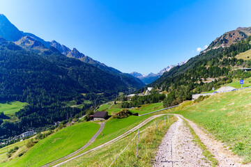 Scenic landscape at hiking trail above mountain village of Airolo in the alps on a sunny late summer day. Photo taken September 10th, 2023, Gotthard, Switzerland.