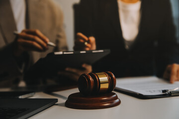 Lawyer, legal advisor, businessman brainstorming information on agreement details Business contracts in legal processing books for accuracy in contract documents. joint financial investment.