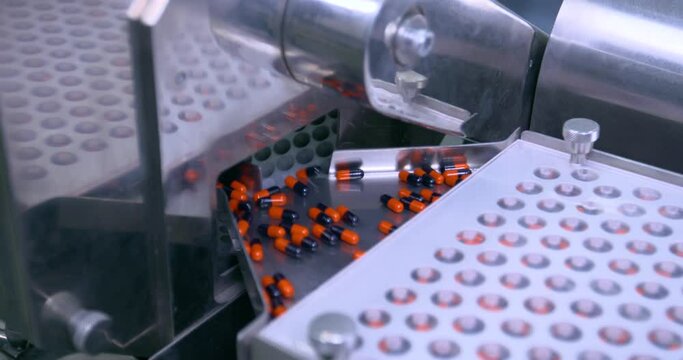 medicine capsule pharma concept. capsules in a machine. production process. pill packaging machine. manufacturing medicine in pharmaceutical factory.  machine in pharma manufacturing factory.