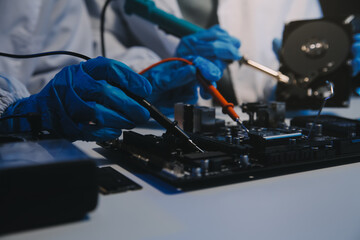 Obraz premium Close up of Technician measuring voltage electronic circuit board television, Service after sale fix electric equipment within insurance.