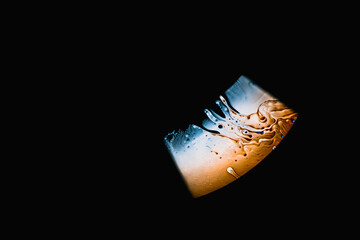 Close-up of a soap foam bubble with iridescent surface area on a black background