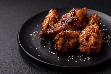 Delicious crispy grilled wings with teriyaki sauce with salt, spices