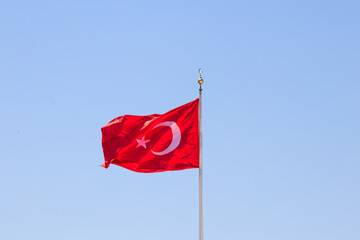Turkish flag against blue sky.  Red Turkish flag on the flagpole. Victory, independence idea concept. 