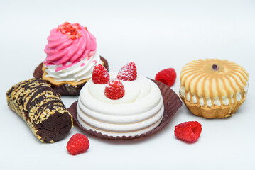 Various delicious sweet cakes, delicious food, snacks for tea and coffee. Confectionery products on a white background. Cakes set with raspberries, fudge, chocolate.