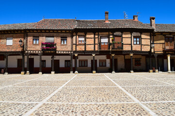 Timber frame houses on pillar / colonnade lined portico on Spanish cobbled square
