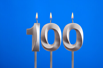 Birthday candle number 100 - Celebration card on blue background