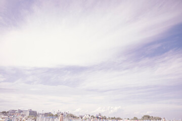 Obraz premium Typical Italien beach with lounge chairs and umbrellas with playground in the background.