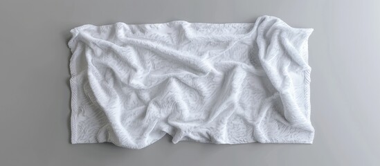 Obraz premium Mock-up of a white beach towel isolated with clipping path on a grey background in a top-down flat lay view