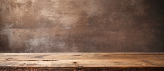 Wooden table displayed against a textured grunge wall background with copy space image.