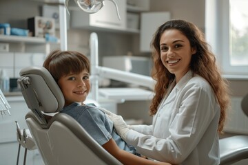 Fototapeta premium smiling boy at a dentist appointment sitting in a dental chair next to the doctor