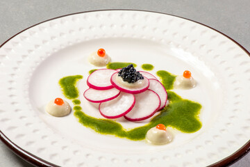 Gourmet appetiser with caviar and radish