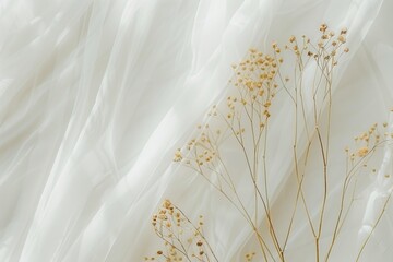 Elegant dry flowers against flowing white fabric backdrop