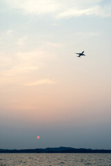 View of the flying airplane during sunset