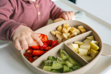 Baby eats food independently using self-feeding method, blw,