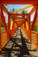 An orange color bridge made of iron & steel