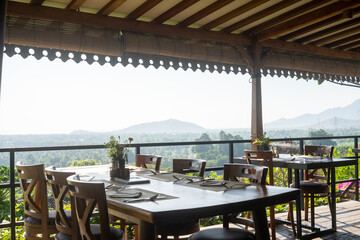 a restaurant with a view of mountains and a table