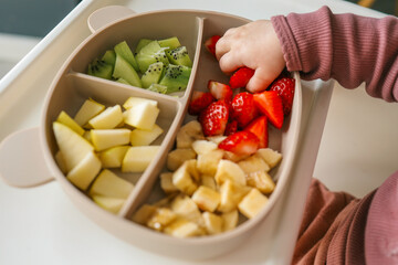 Baby eats food independently using self-feeding method, blw,