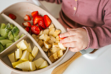 Baby eats food independently using self-feeding method, blw,