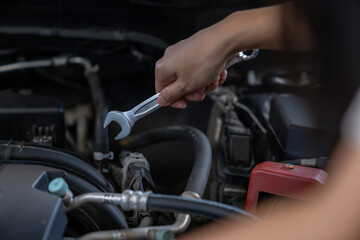 A woman checks the engine condition before setting off on a journey