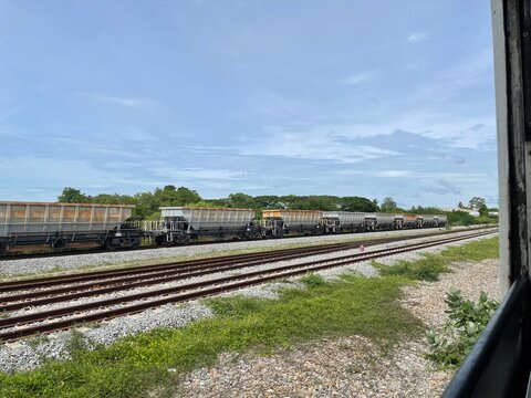 Image of a railway track with a stone transport train parked on the tracks.