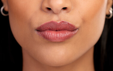 Naklejka premium Woman, mouth and lipgloss for beauty in studio, textures and skincare on black background. Female person, lips and shine for filler or dermatology, treatment and skin textures for grooming or glow