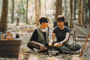 Asian couple sweet in tent inside on they camping trip, traveller relax and sleep togather in out door and camping trip - Powered by Adobe
